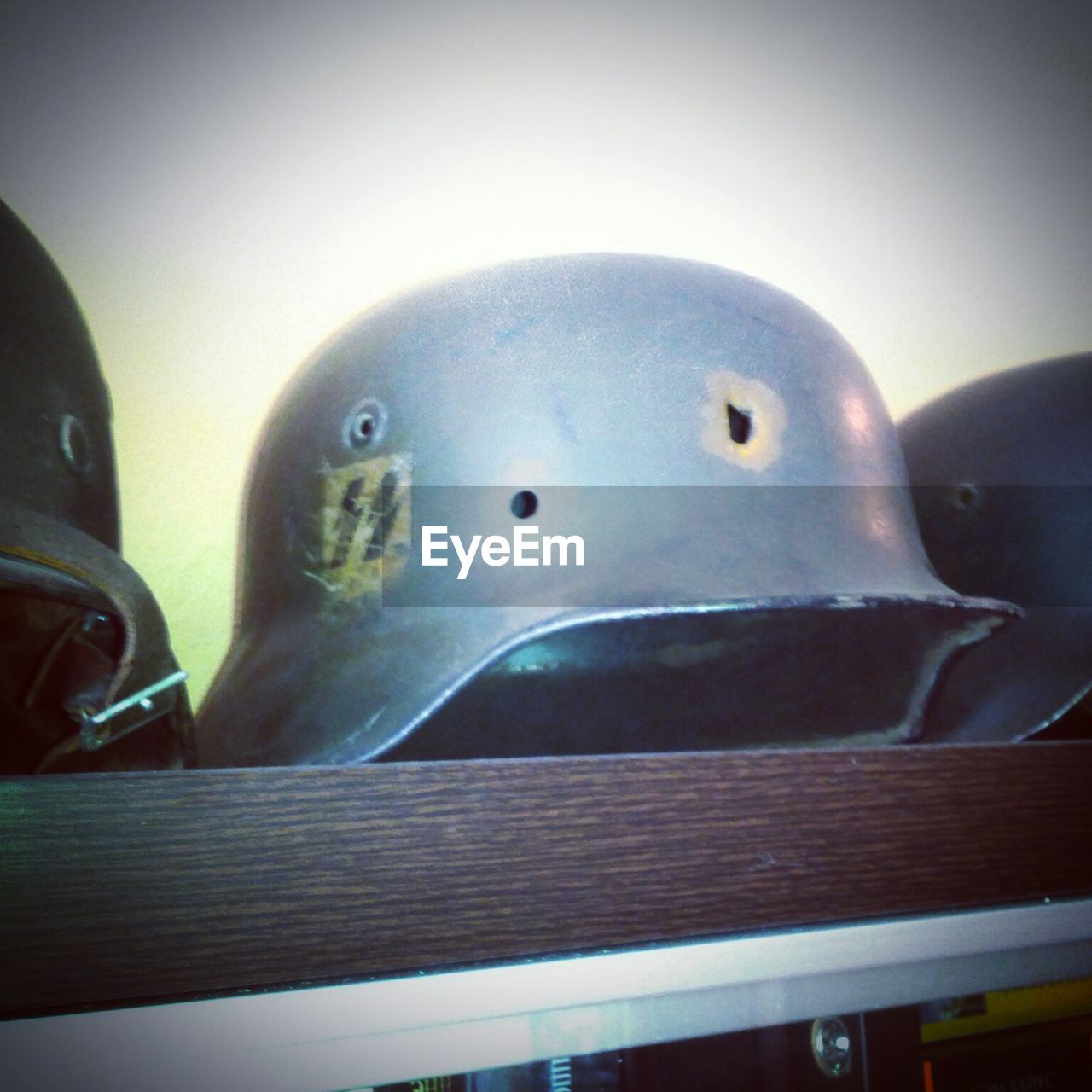 Close-up of army helmets in shelf