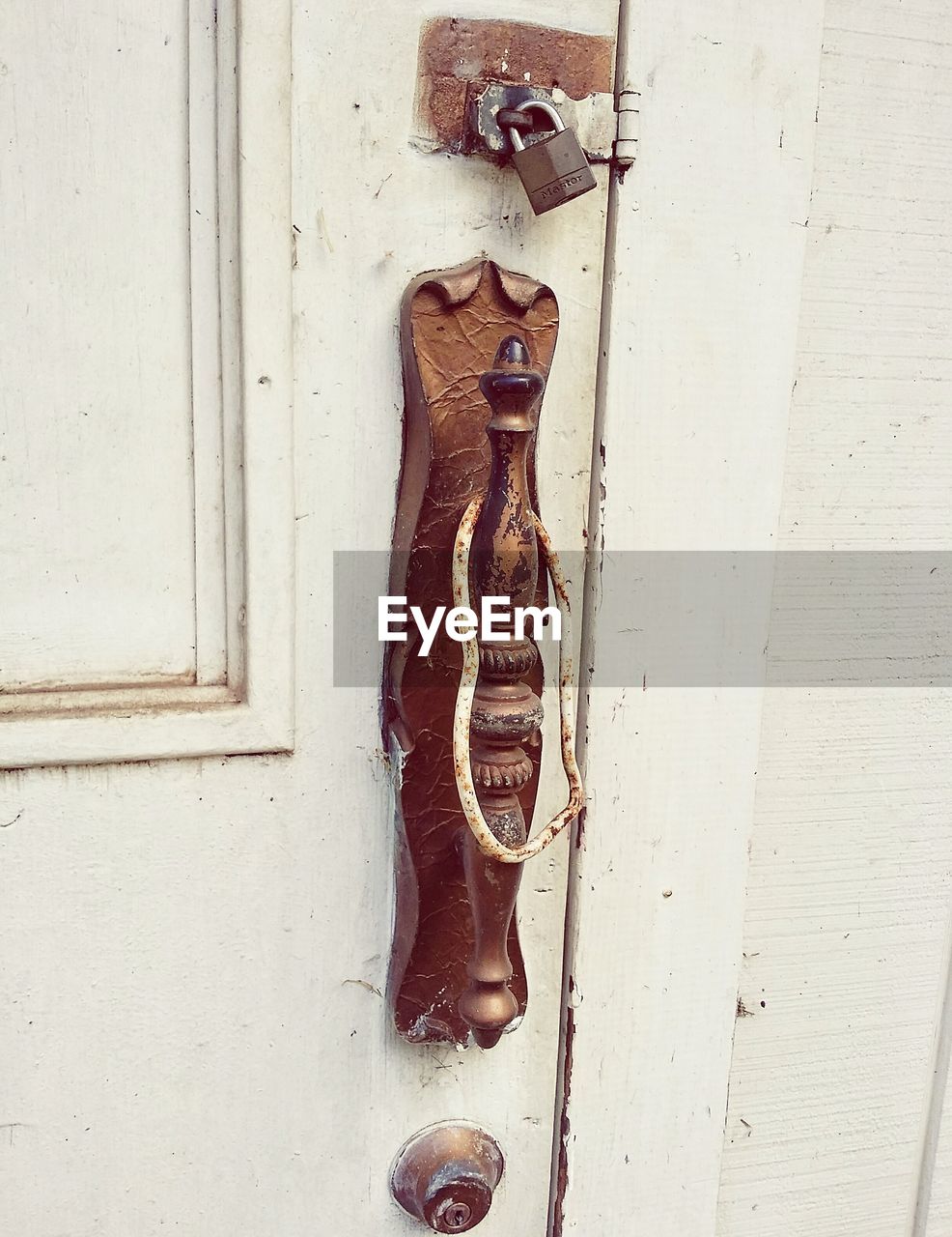 CLOSE-UP OF OLD METAL DOOR WITH WALL