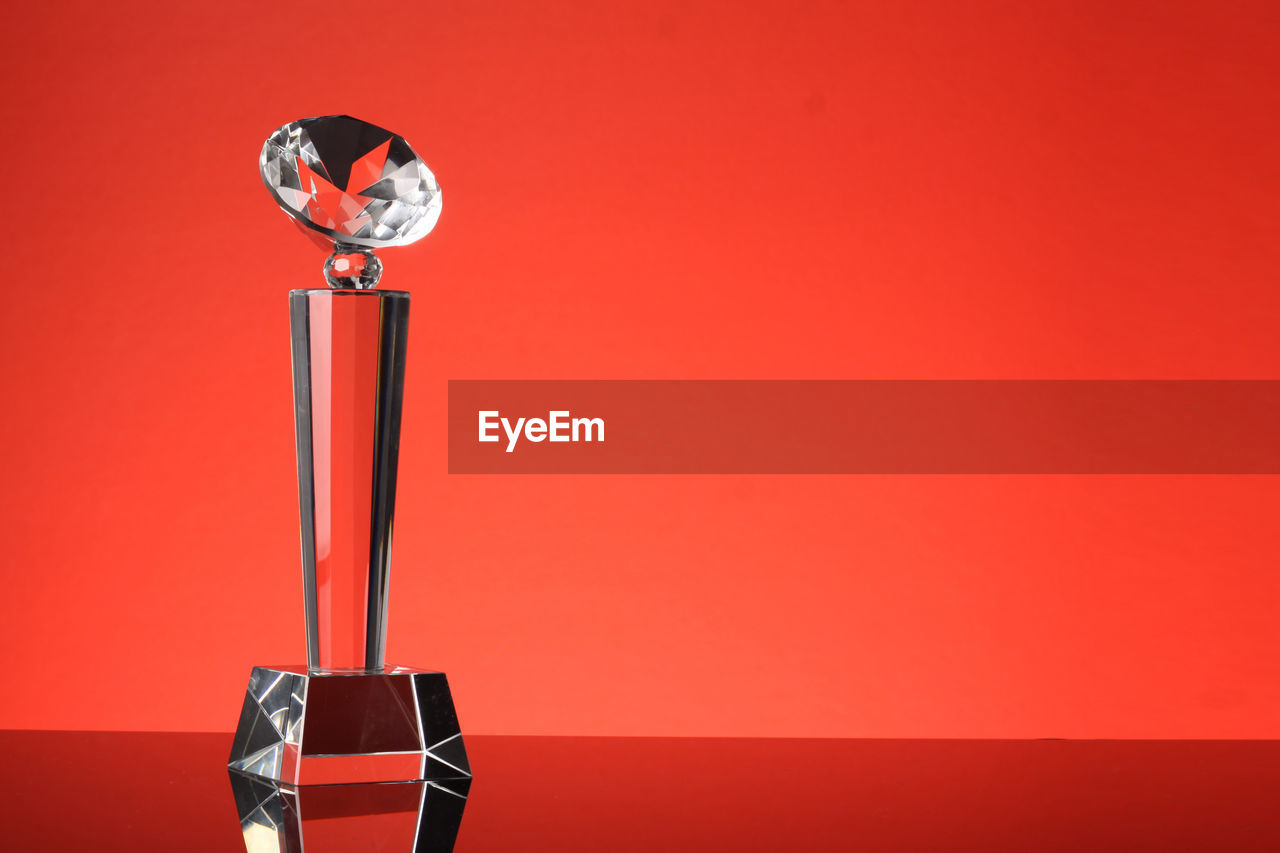 Close-up of award against red background