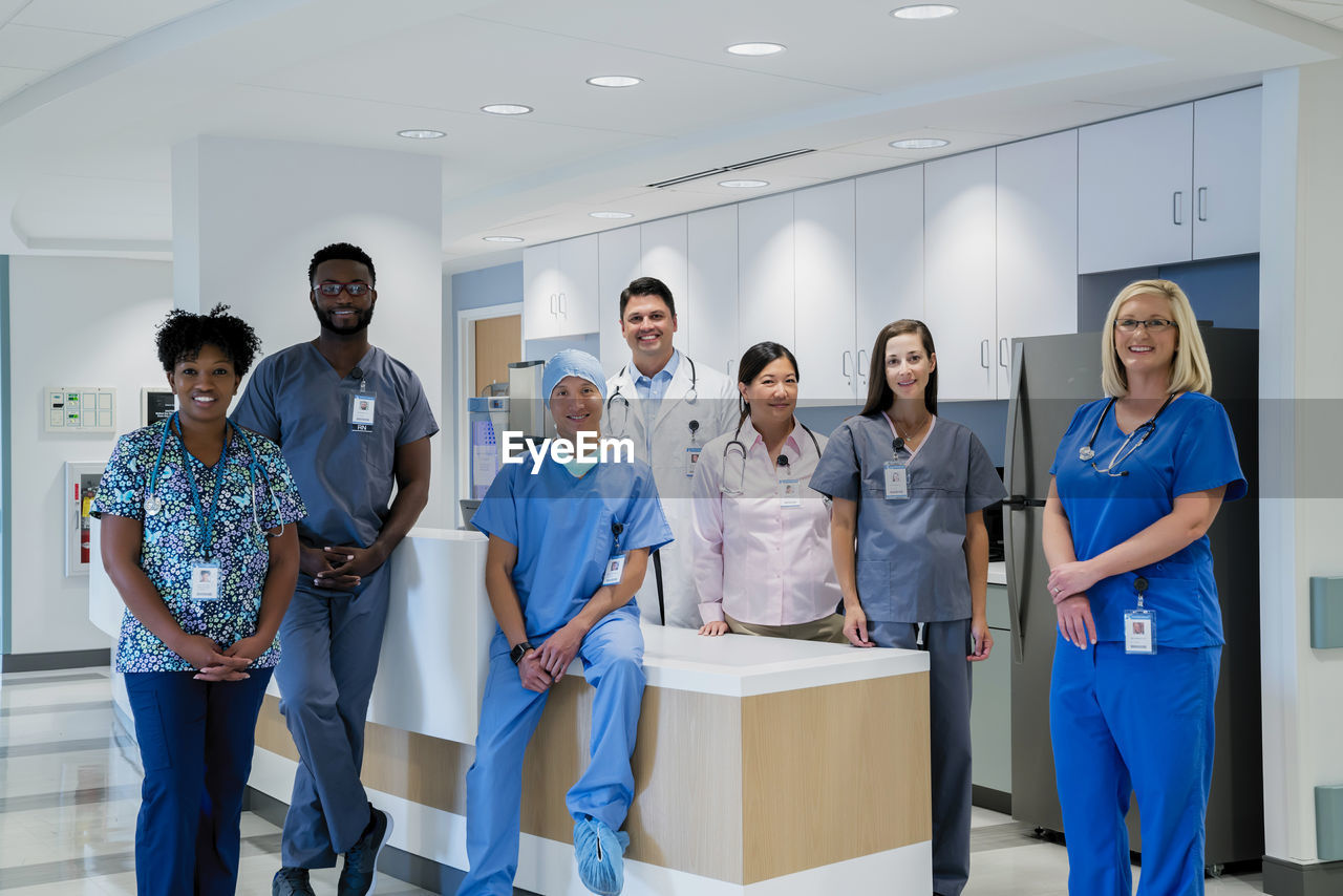 Portrait of smiling doctors and nurses at hospital reception