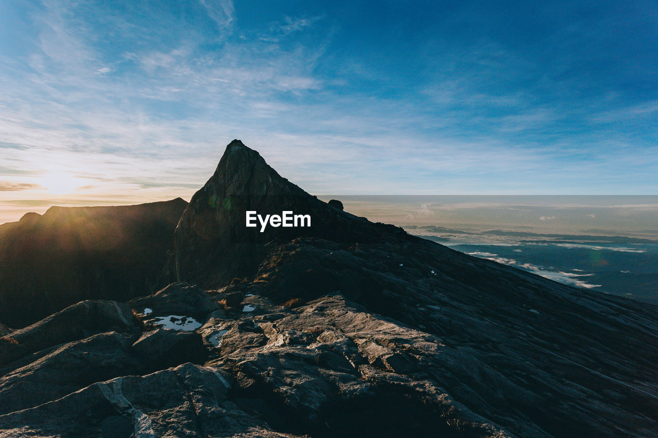 SCENIC VIEW OF MOUNTAIN AGAINST SKY AT SUNSET