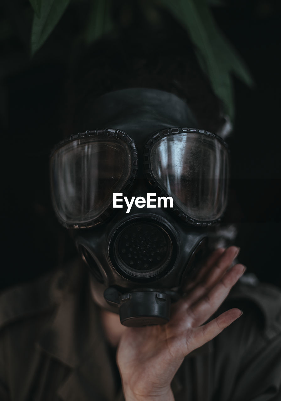 Portrait of woman wearing gas mask