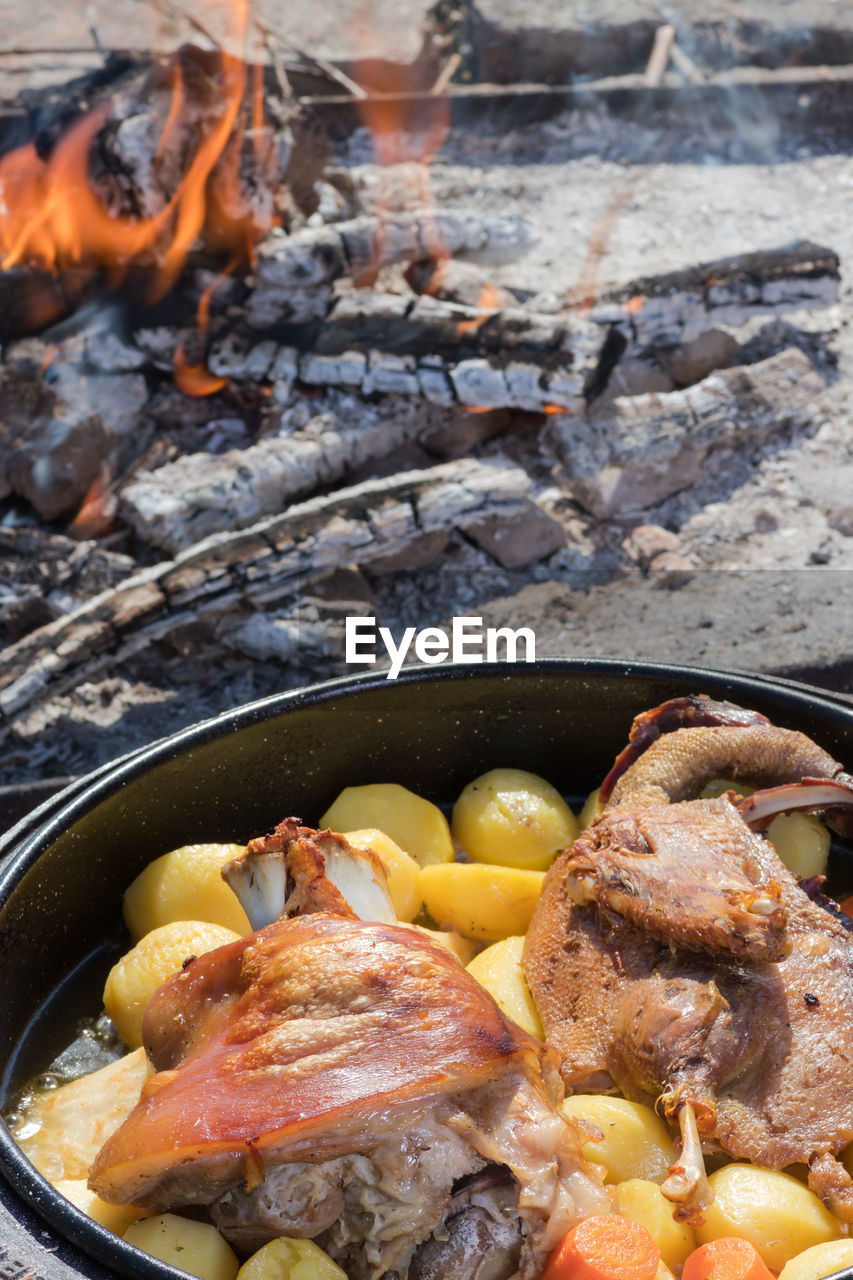 Cooking of traditional croatian meal peka in metal pots called sac, sach or sache. 