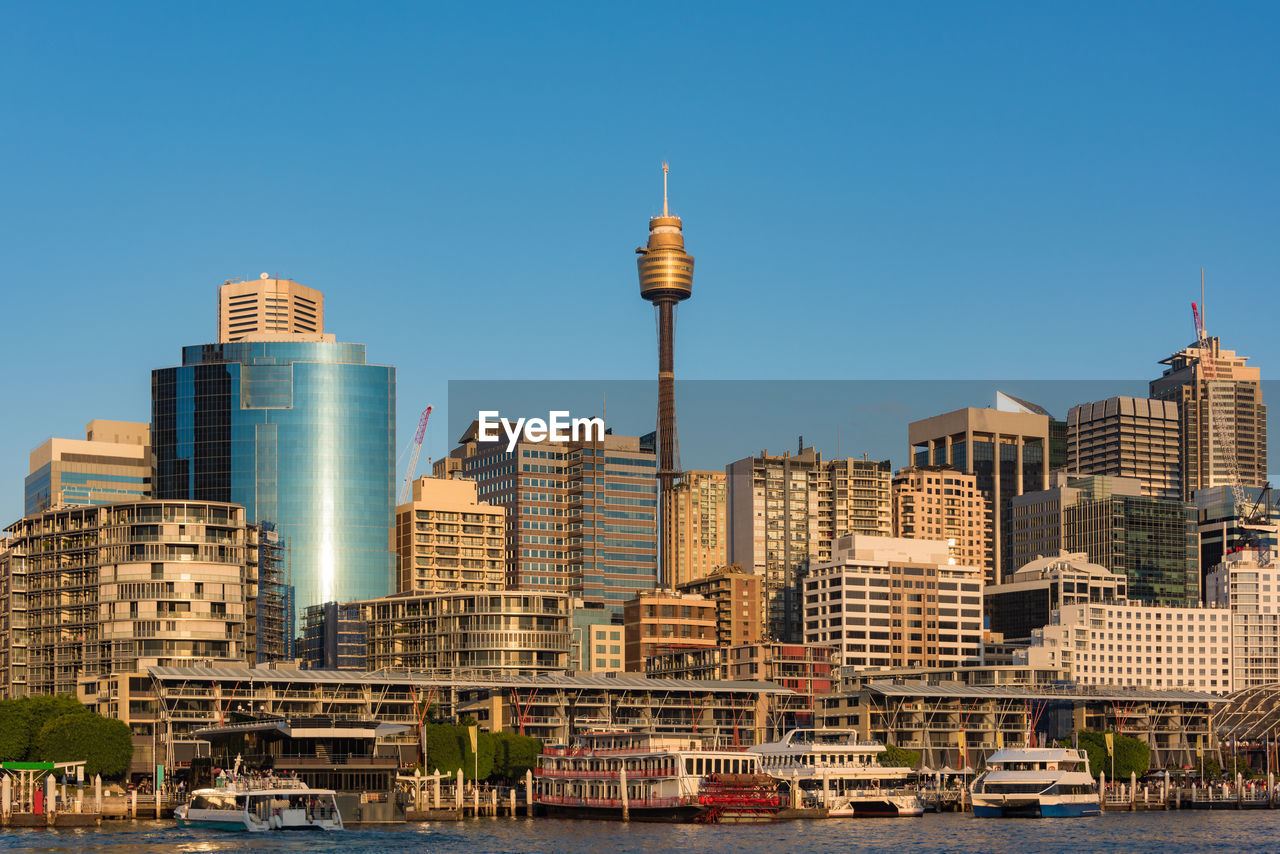 Buildings in city against clear sky