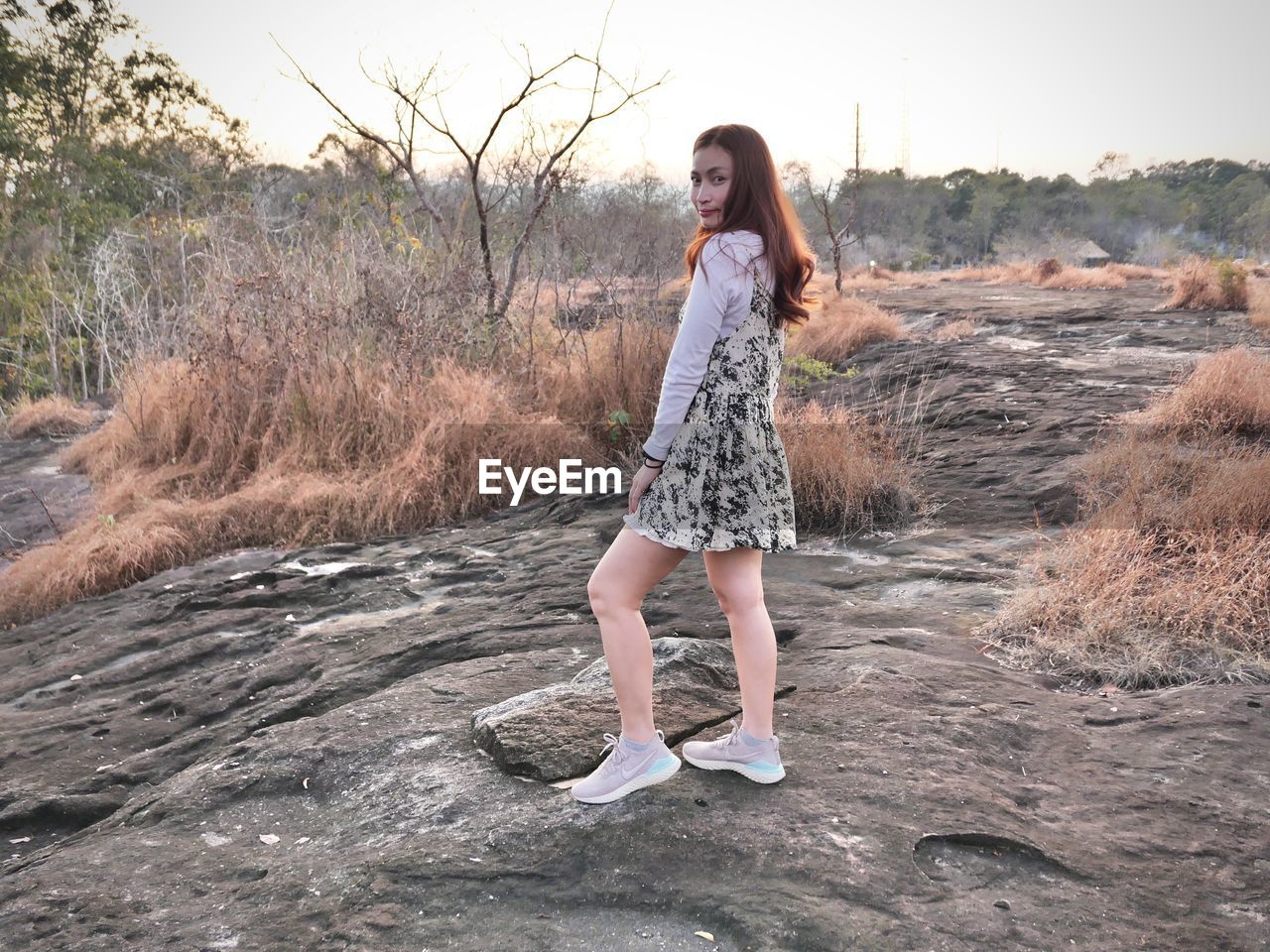 Full length portrait of young woman standing outdoors