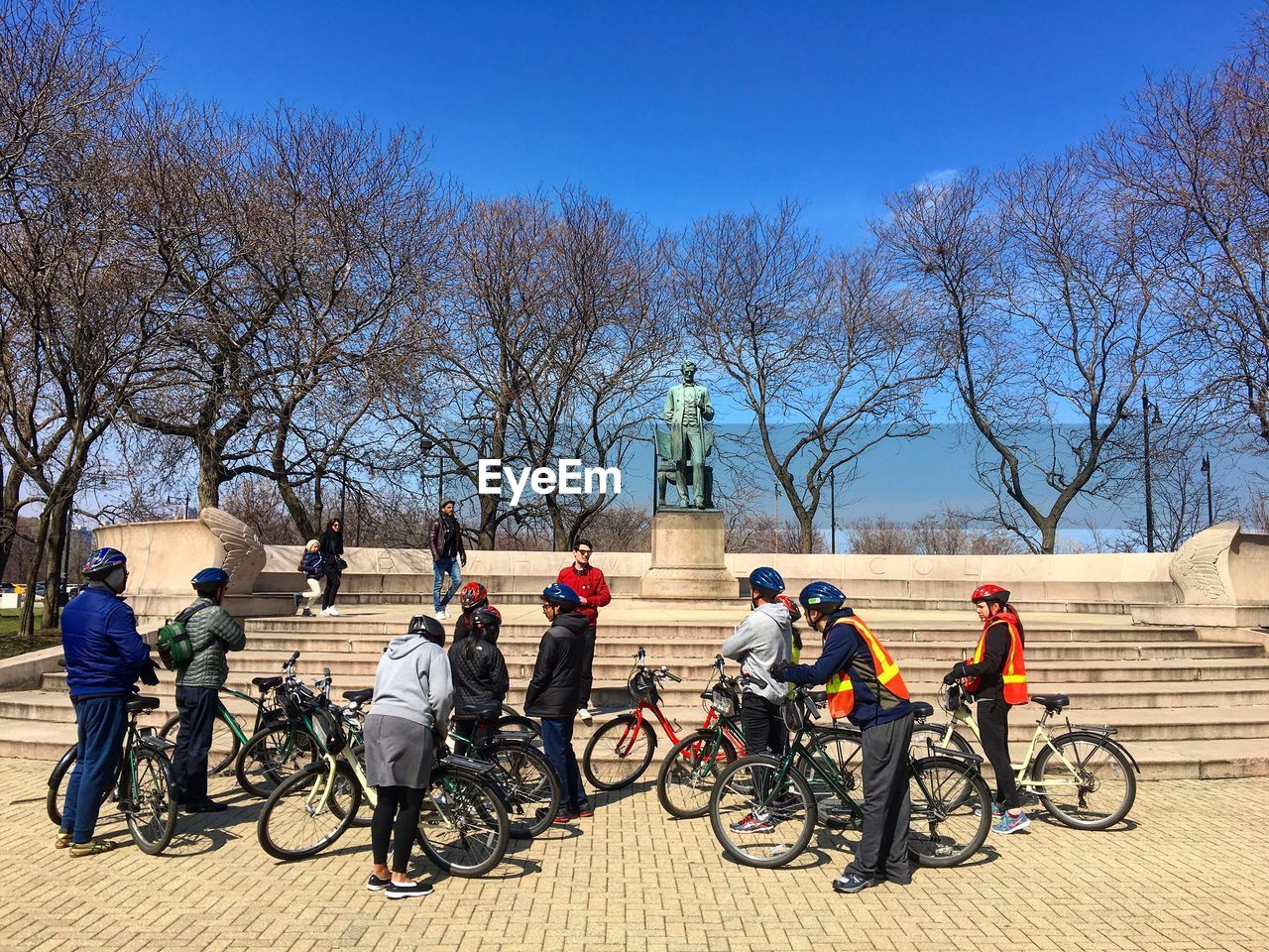 MAN RIDING BICYCLE ON WALKWAY