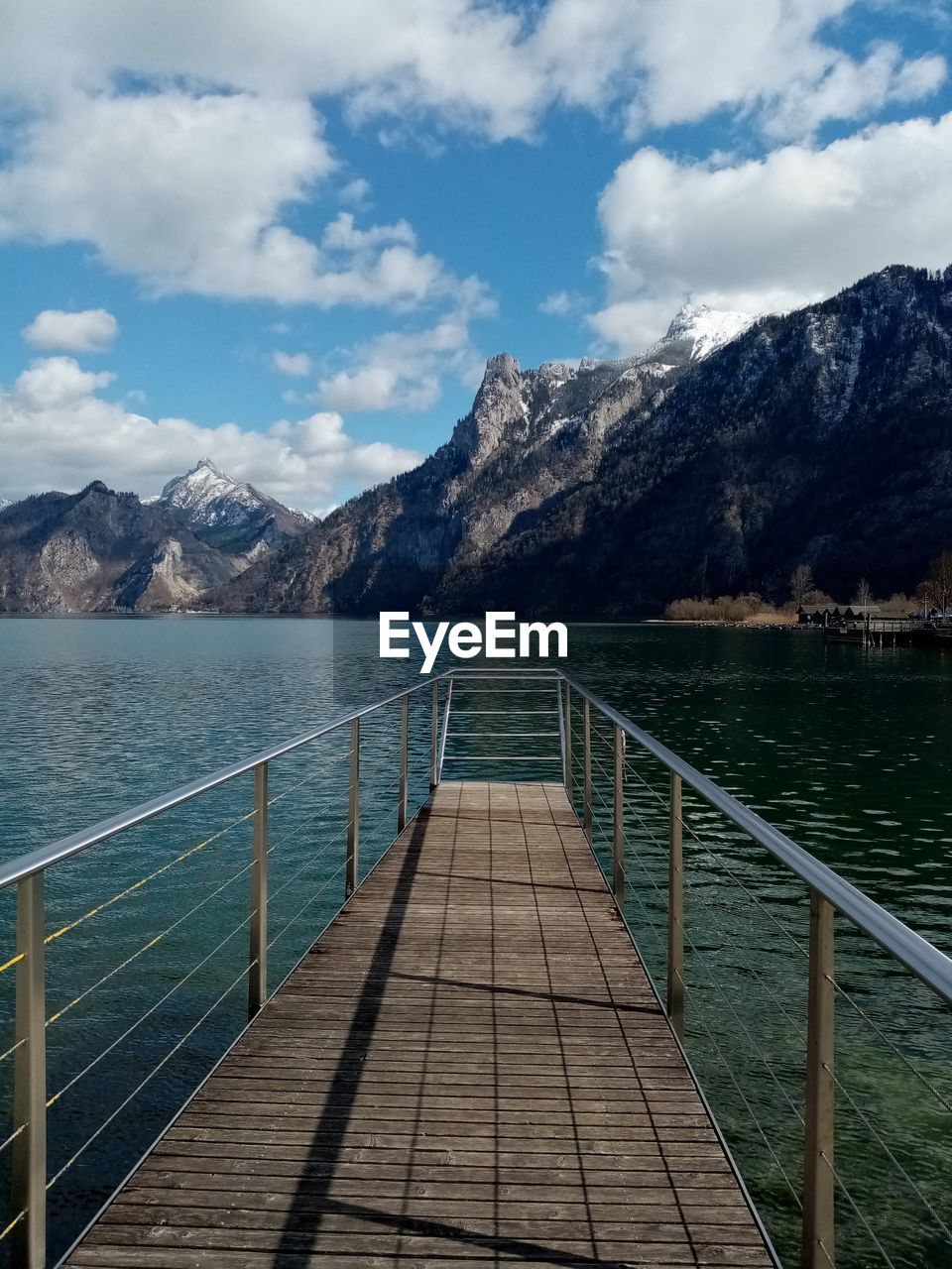 Pier over lake against sky