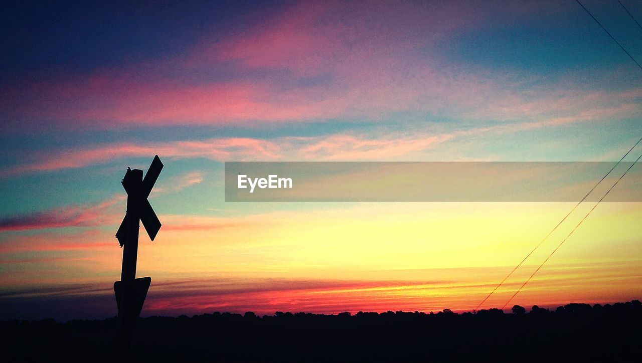 SILHOUETTE OF TREES AT SUNSET