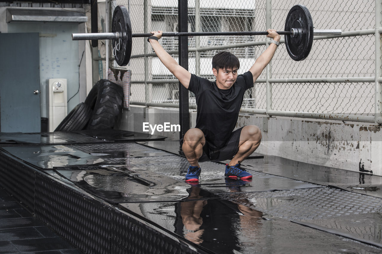 Man training at rooftop gym in bangkok