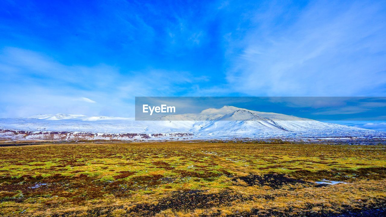 SCENIC VIEW OF SNOWCAPPED MOUNTAIN AGAINST BLUE SKY