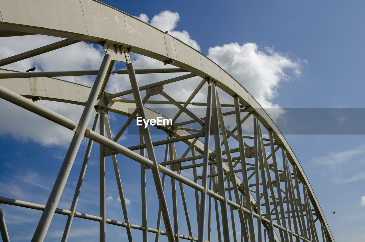 LOW ANGLE VIEW OF METALLIC BRIDGE AGAINST SKY