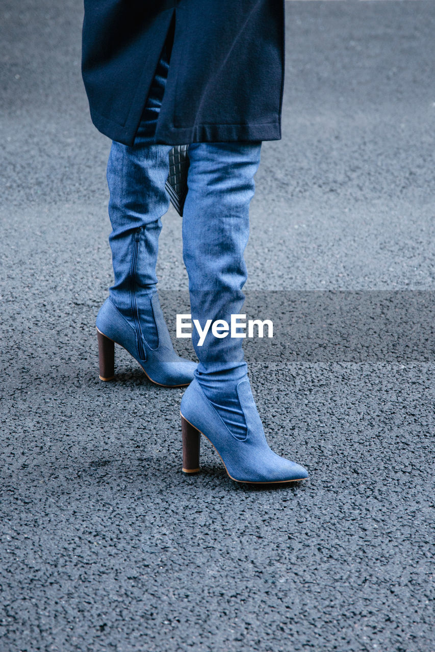 LOW SECTION OF MAN WALKING ON STREET