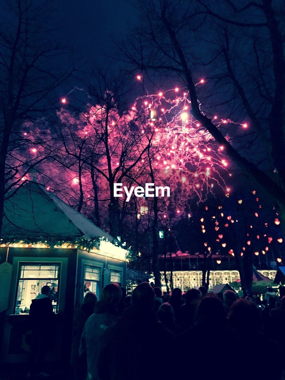 ILLUMINATED CHRISTMAS TREE IN CITY AGAINST SKY