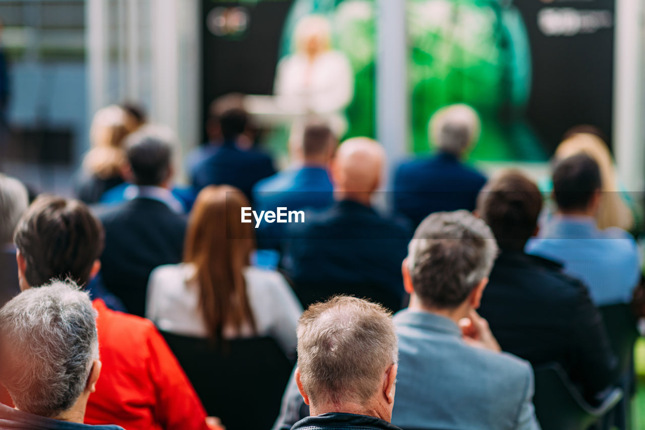 Unrecognizable group of people sitting, attending a seminar or a business presentation