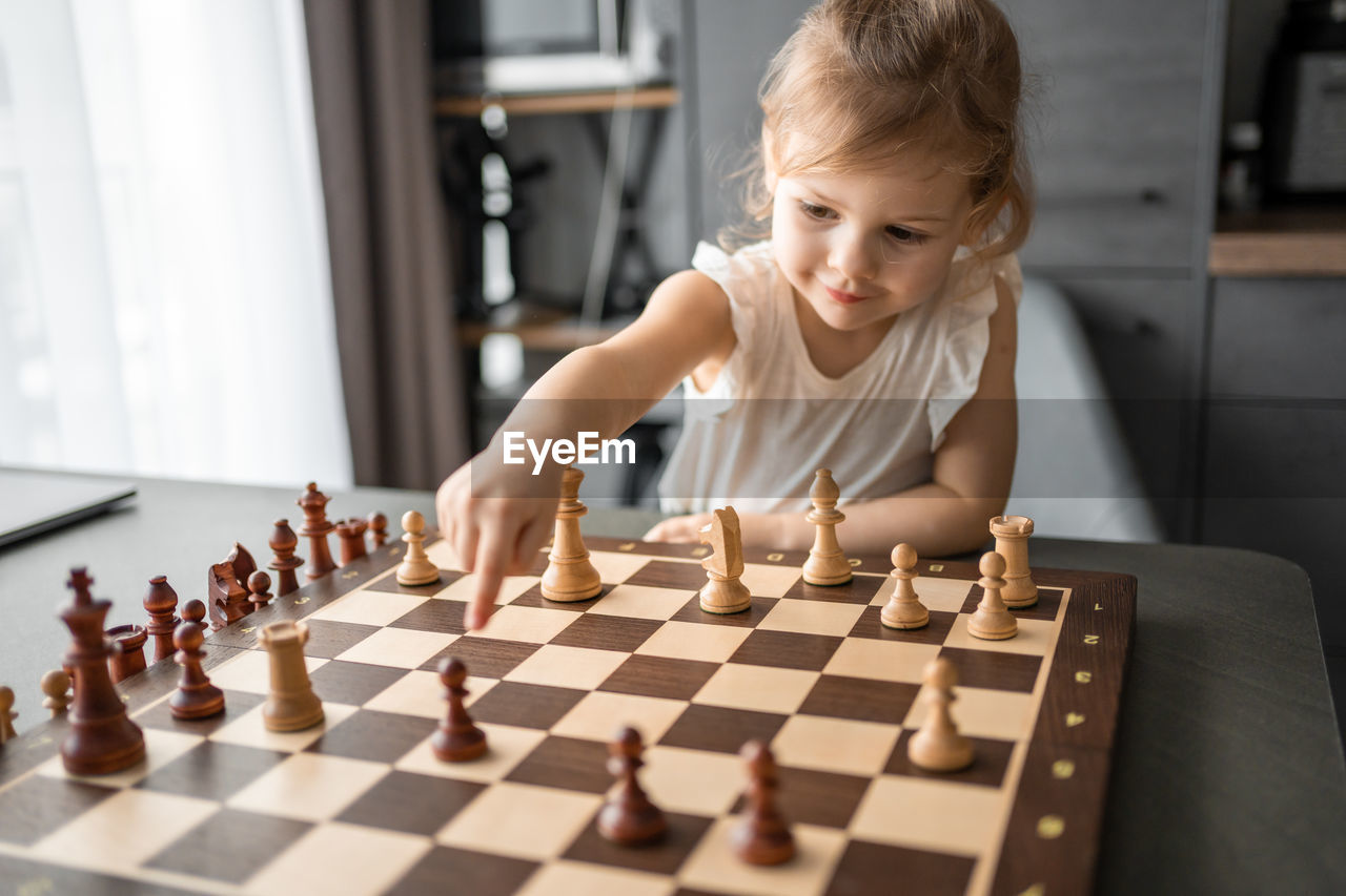 girl playing chess