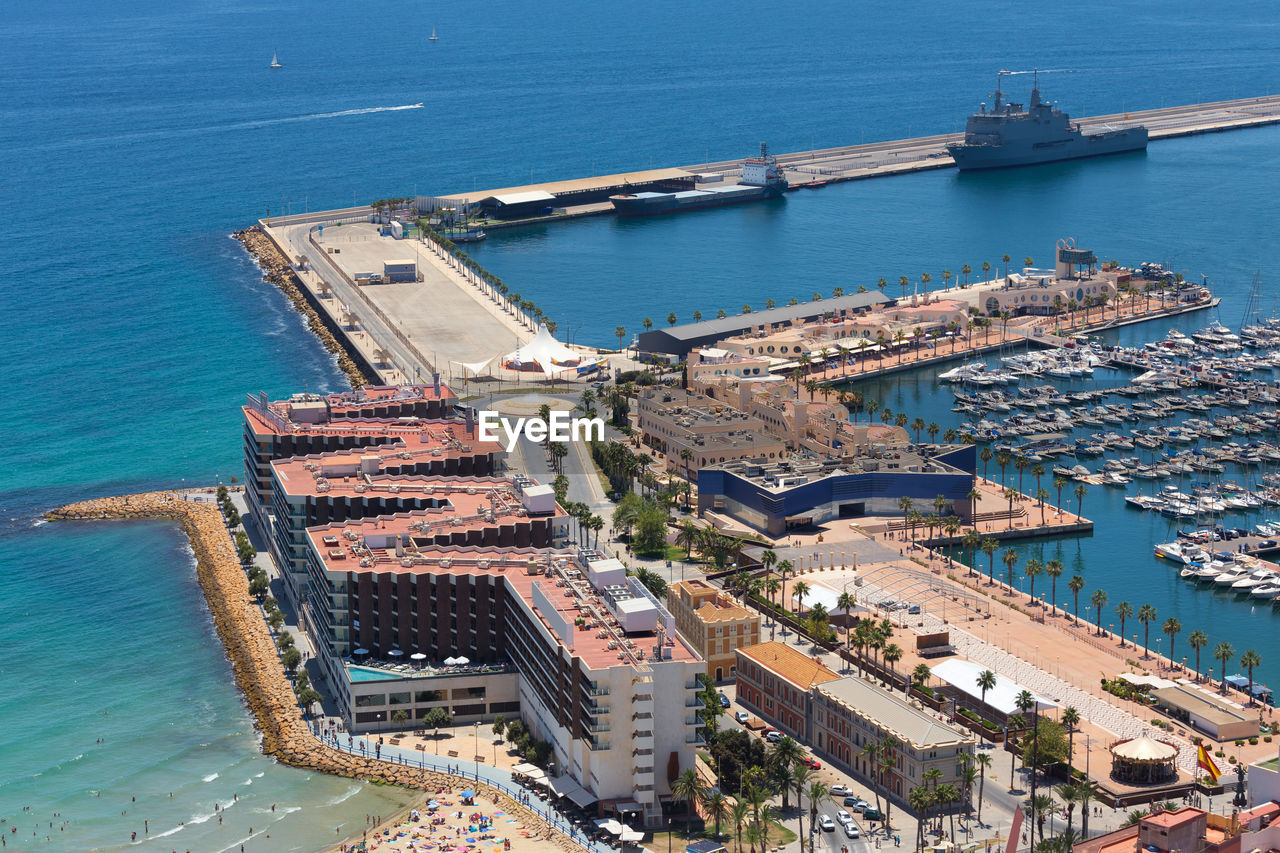 HIGH ANGLE VIEW OF CITY BY SEA AND BUILDINGS