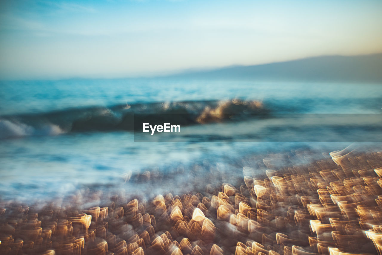 AERIAL VIEW OF SEA AND ROCKS AGAINST SKY