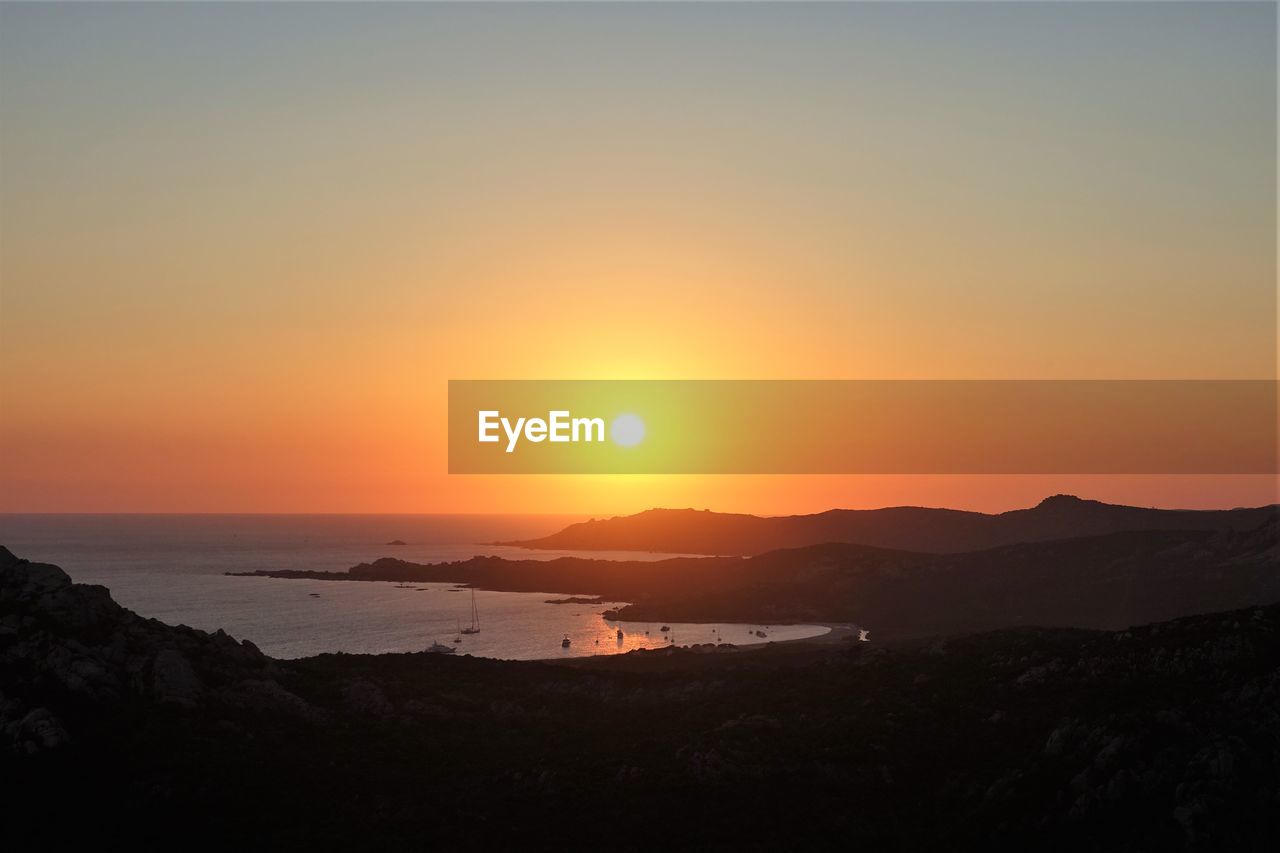 SCENIC VIEW OF SEA AGAINST ORANGE SKY