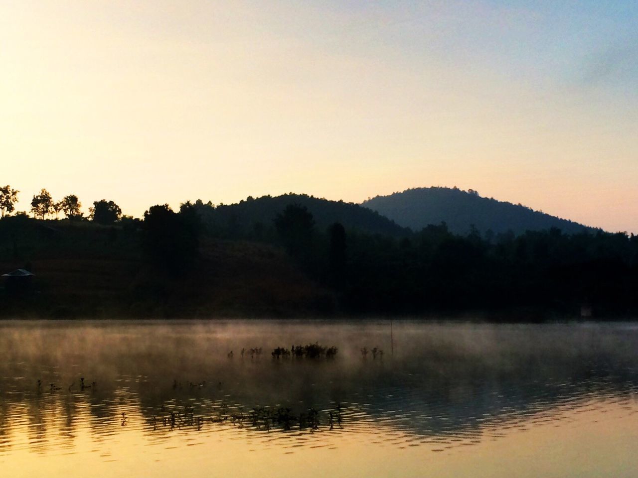 Reflection of mountain in lake during sunset