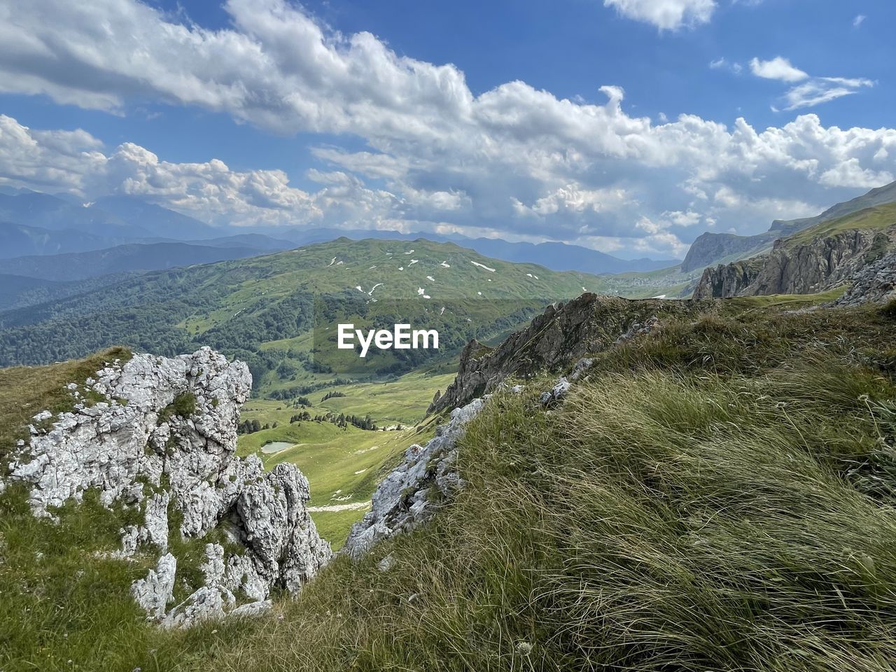 environment, landscape, scenics - nature, mountain, mountain range, sky, cloud, beauty in nature, ridge, nature, mountain pass, land, plant, walking, adventure, travel, grass, travel destinations, wilderness, tranquility, no people, non-urban scene, tranquil scene, meadow, highland, tourism, plateau, outdoors, day, green, valley, tree, rock, pinaceae, idyllic, coniferous tree, summer, activity, pine tree, rural scene, blue, social issues