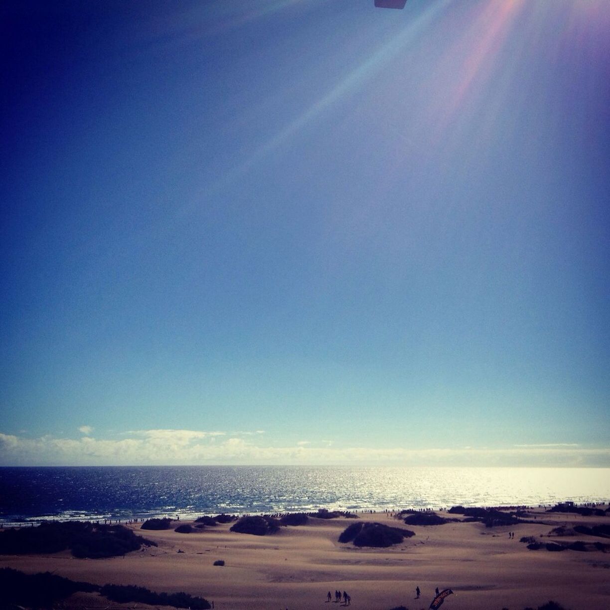 View of calm beach against blue sky