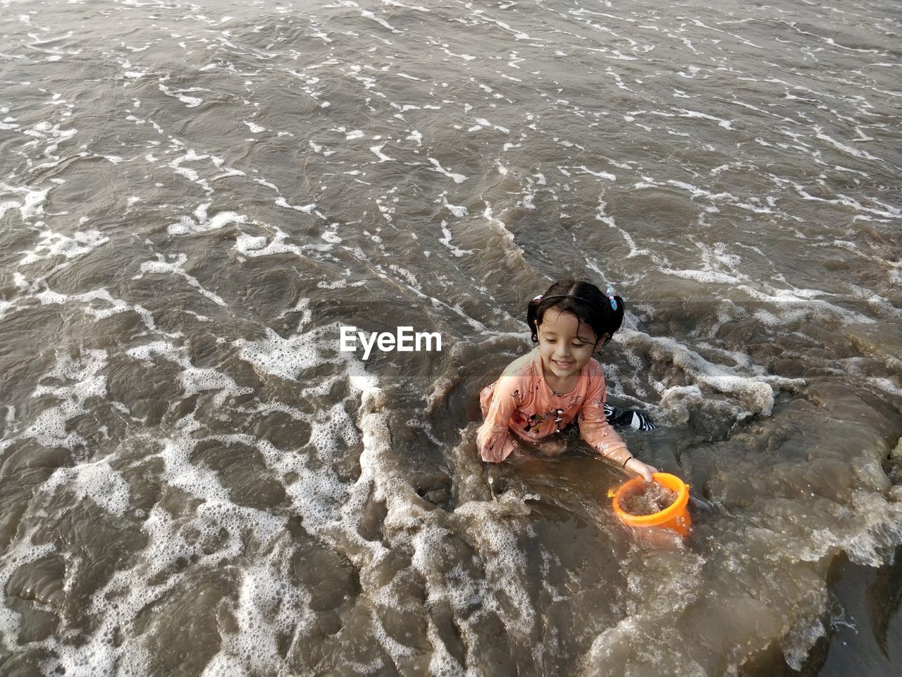 HIGH ANGLE VIEW OF SHIRTLESS MAN AT BEACH