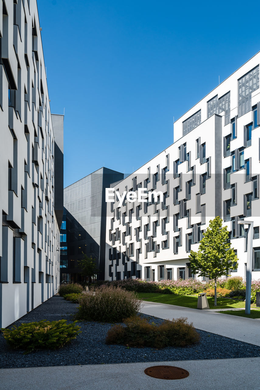 MODERN OFFICE BUILDINGS AGAINST SKY