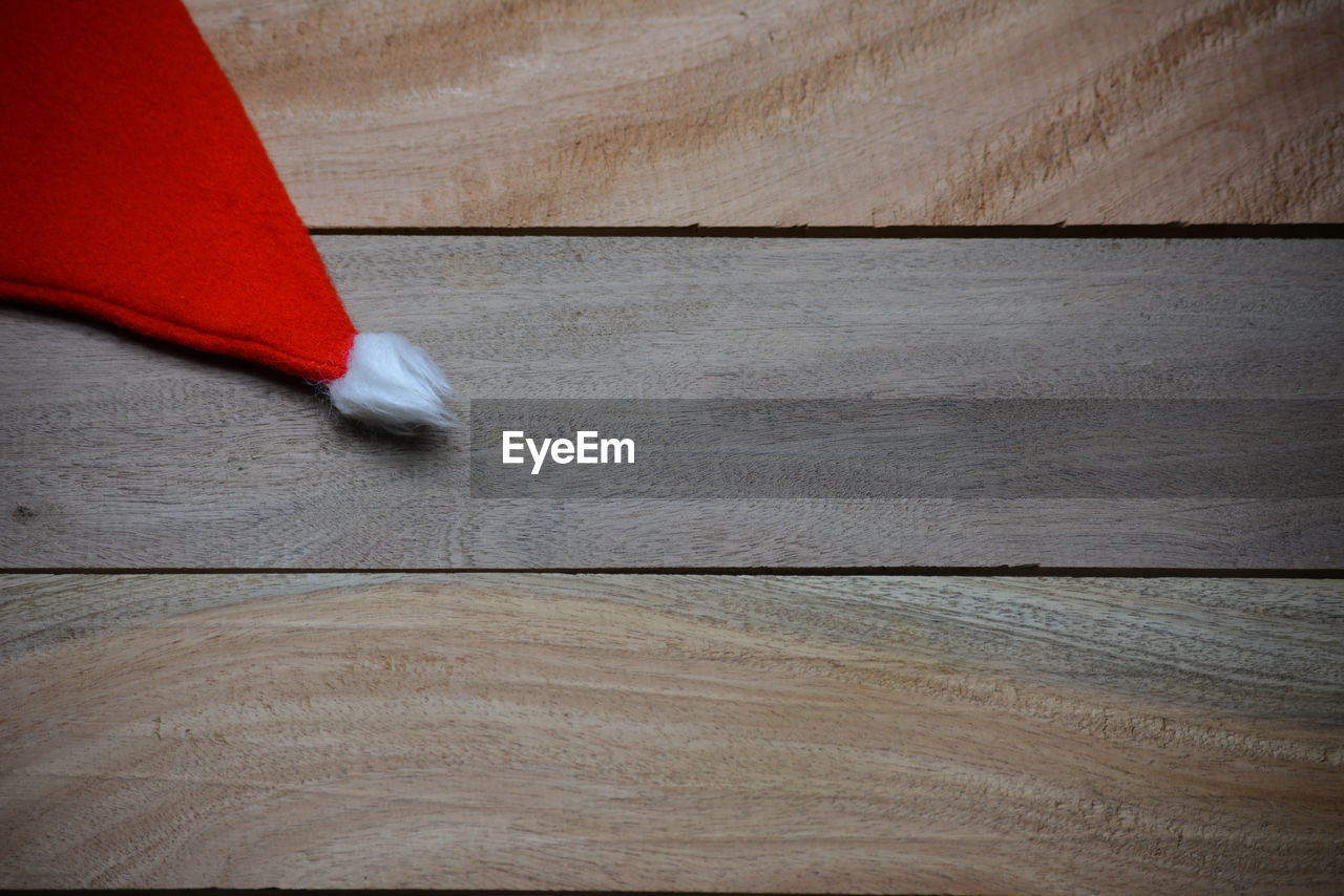 HIGH ANGLE VIEW OF RED WOODEN FLOOR