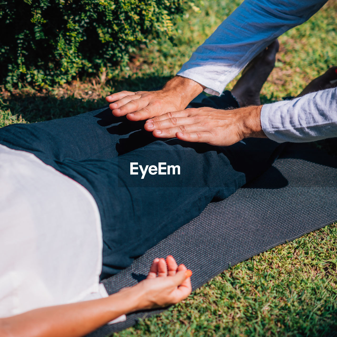 Hands of a reiki therapist healing and balancing energy points in feet. energy healing concept