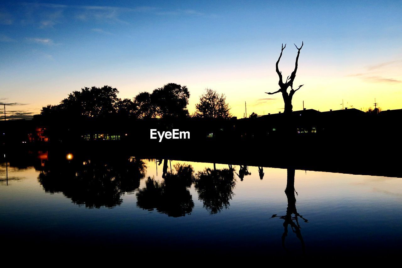 Scenic view of calm lake at sunset