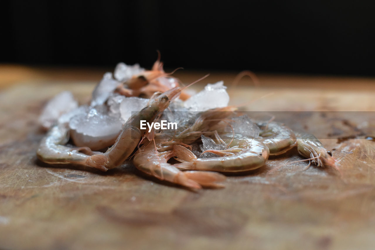 Close-up of fresh frozen shrimps on table