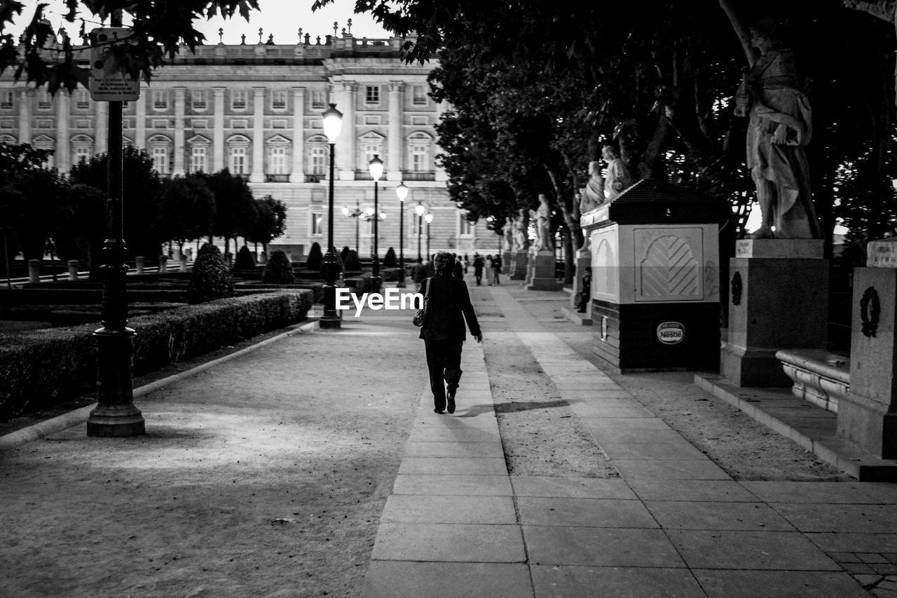 MAN WALKING ON STREET IN CITY