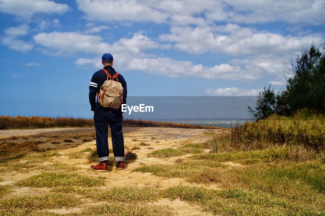 Rear view of man standing on field