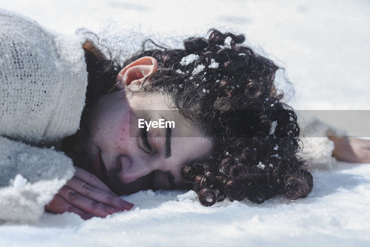 High angle view of young woman in snow