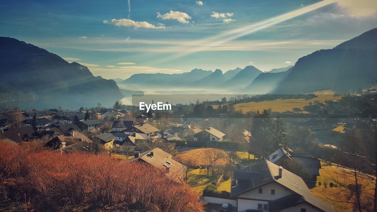 Town by mountains against sky