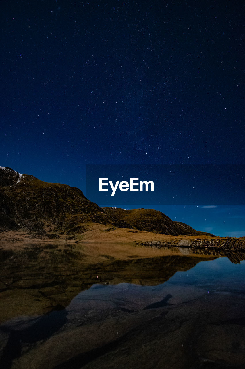 Scenic view of mountains against sky at night