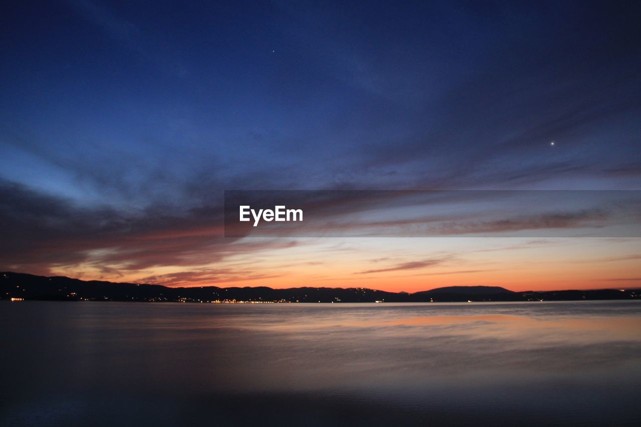 SCENIC VIEW OF SEA AGAINST ORANGE SKY