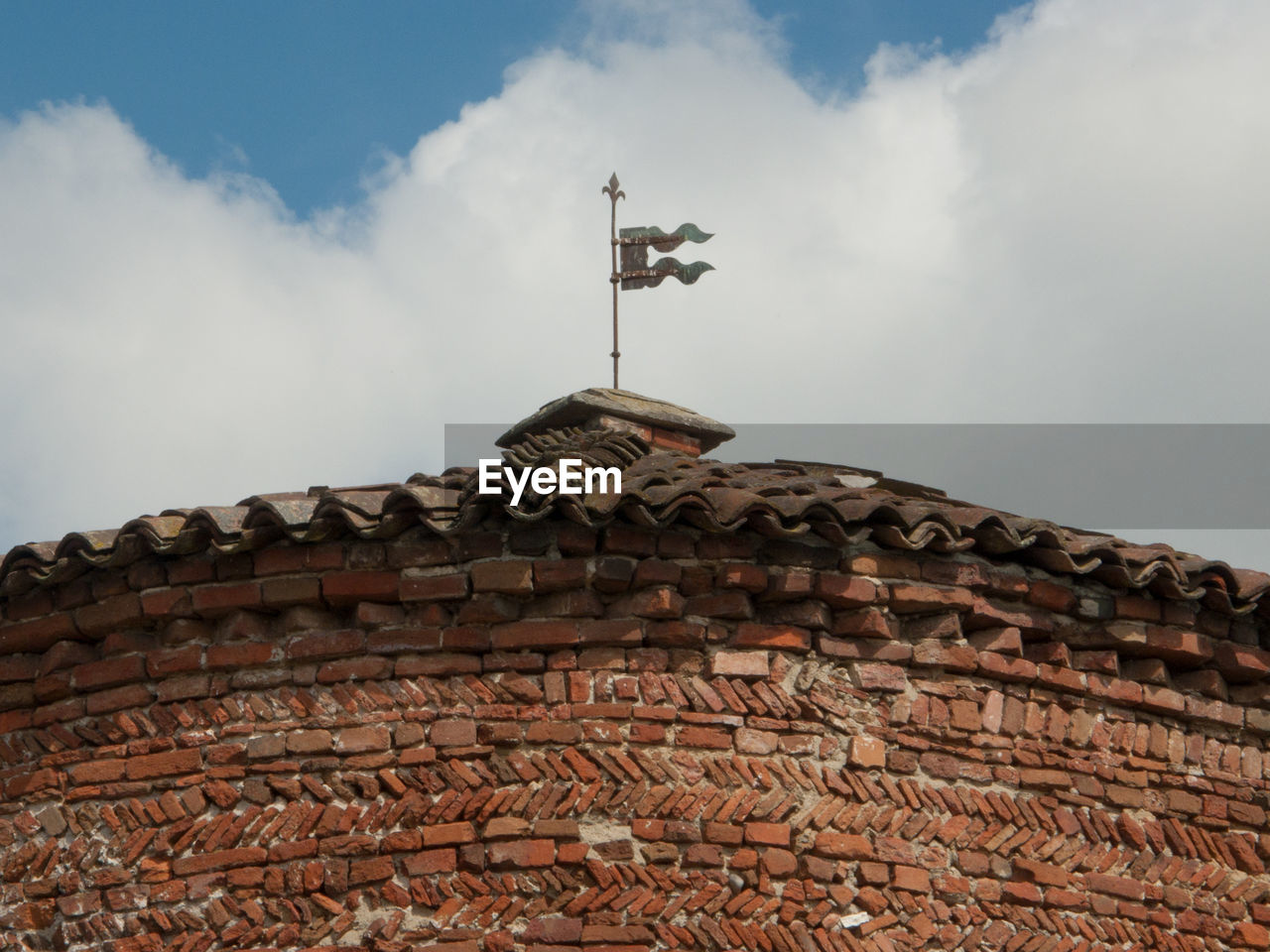 LOW ANGLE VIEW OF WEATHER ON ROOF AGAINST SKY