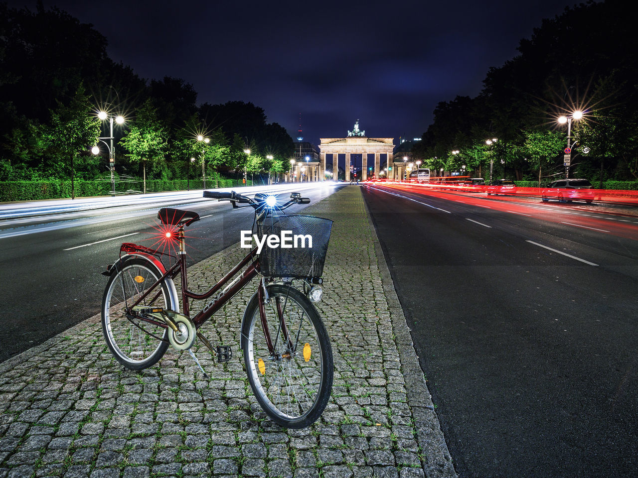 BICYCLES ON STREET IN CITY AT NIGHT