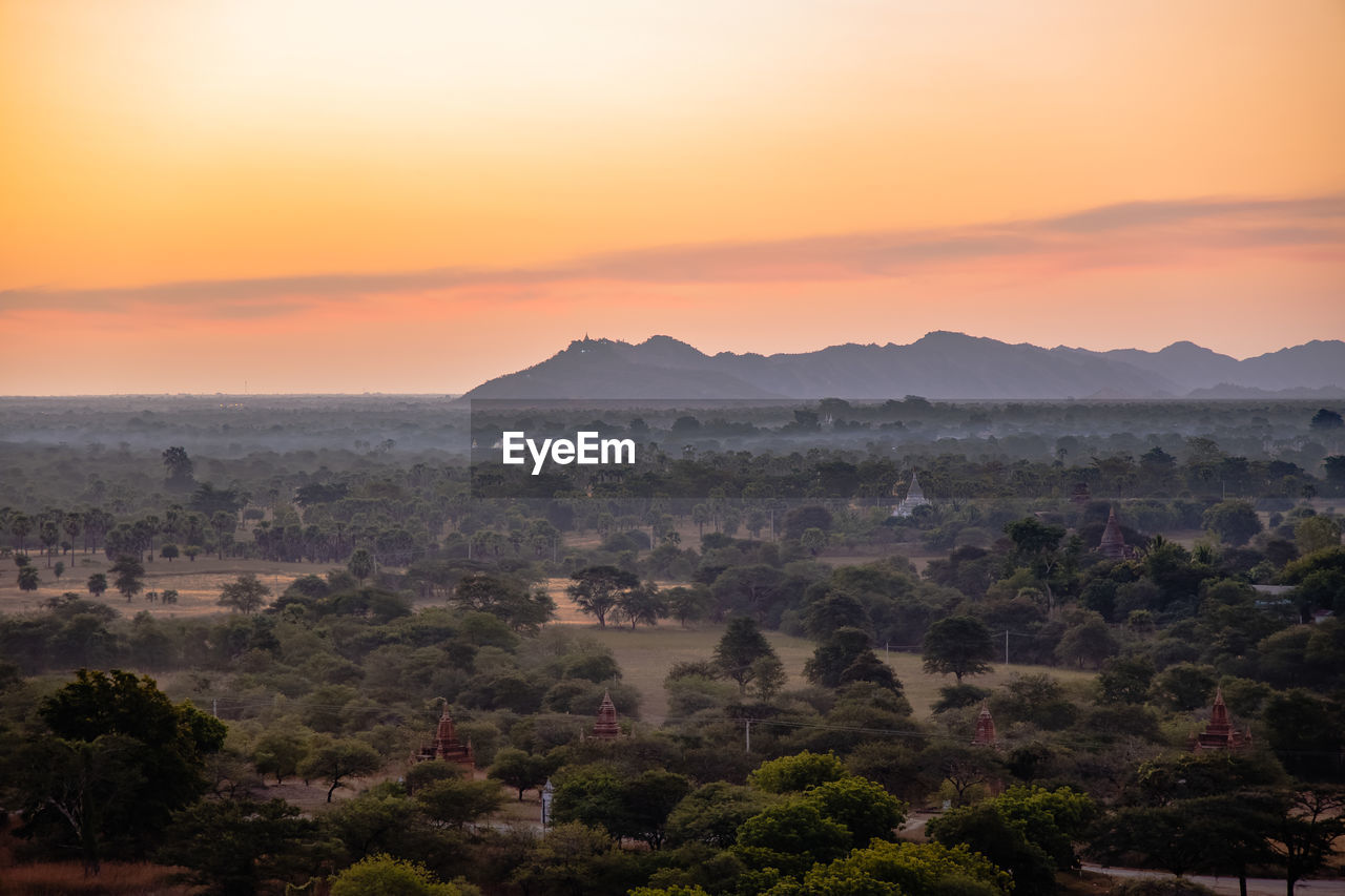 Scenic view of mountains against orange sky