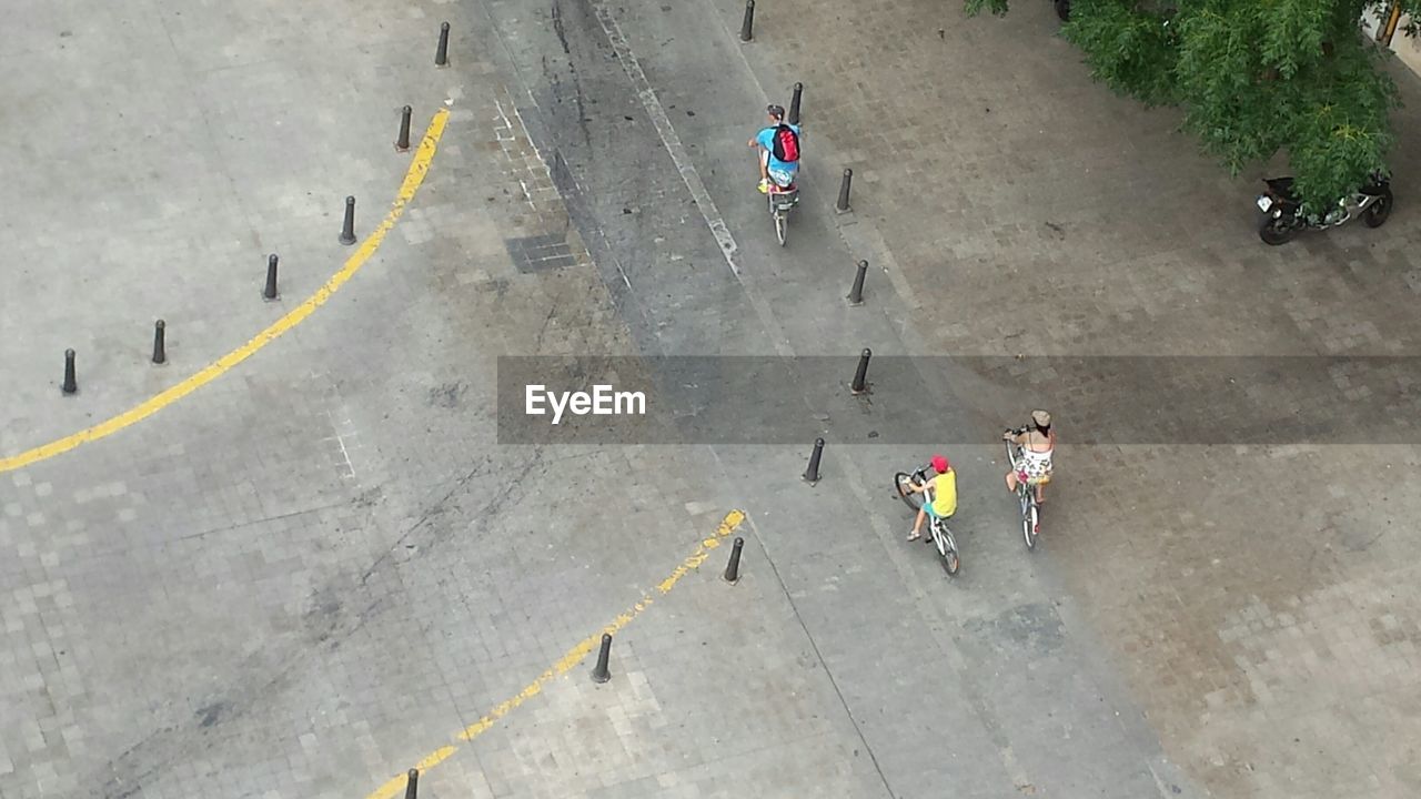 High angle view of people riding bicycle on street