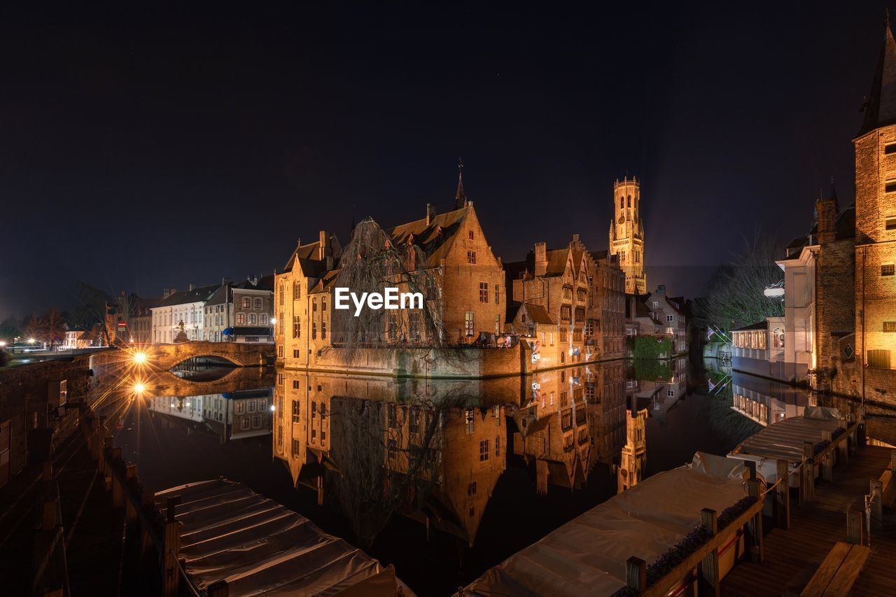 Illuminated buildings in bruges city at night