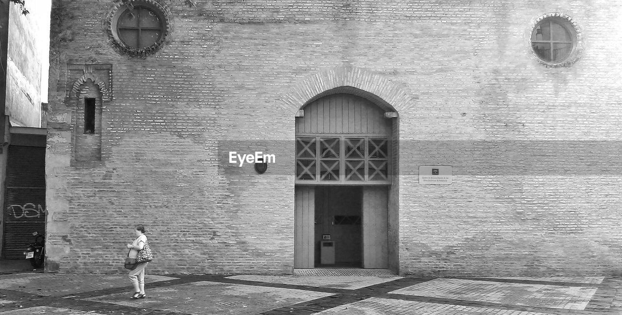 Woman in front of historic building