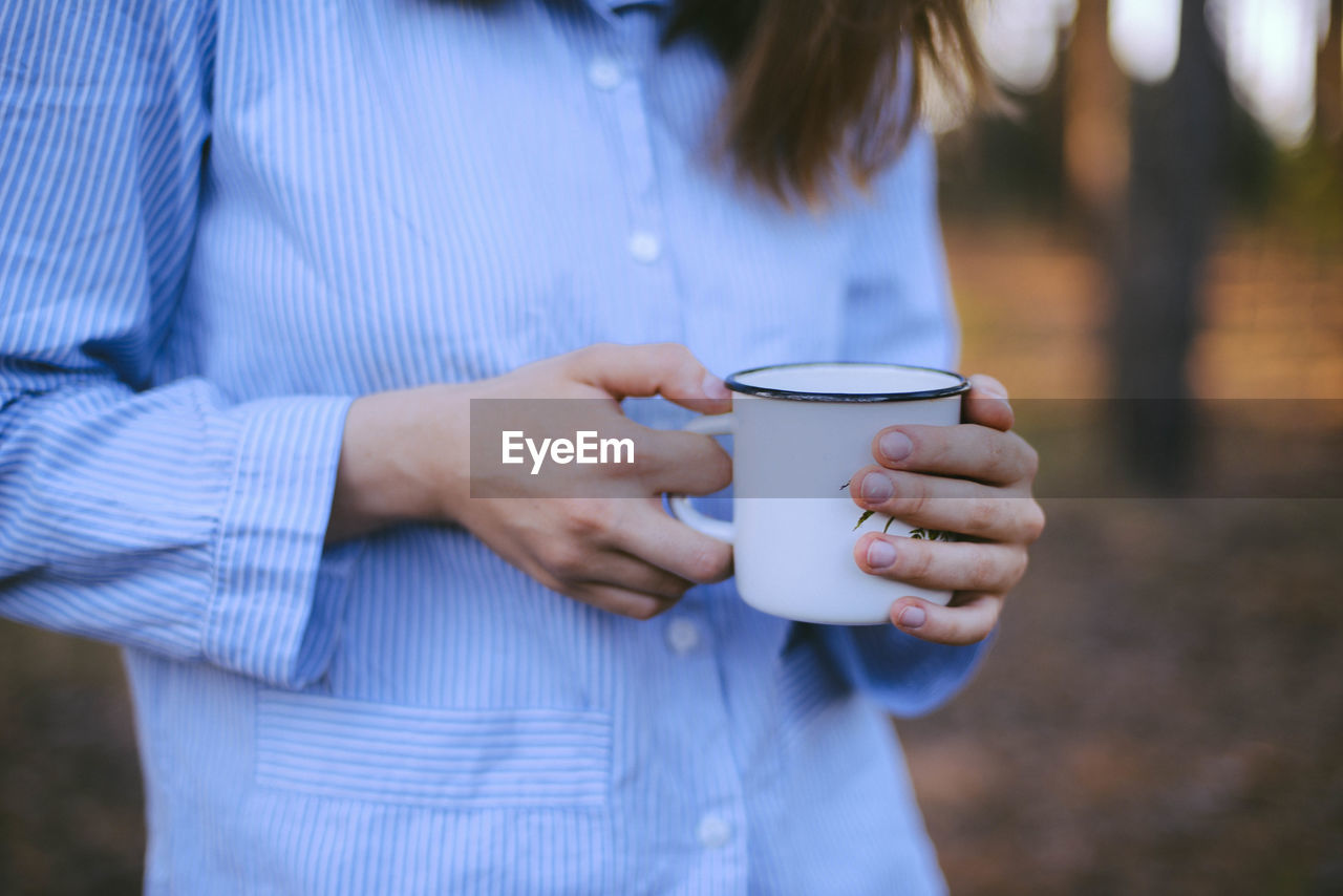 Close-up of woman holding coffee cup