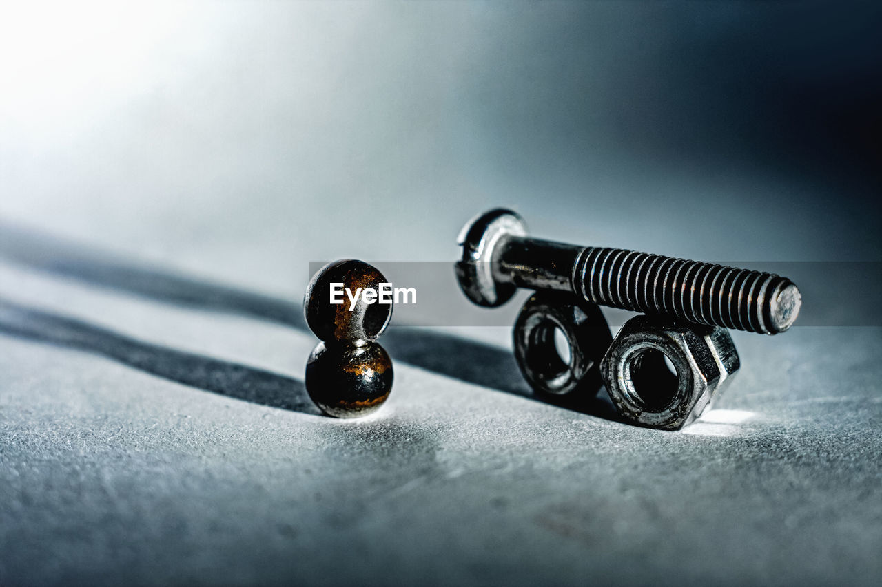 High angle view of nuts and bolt against white background