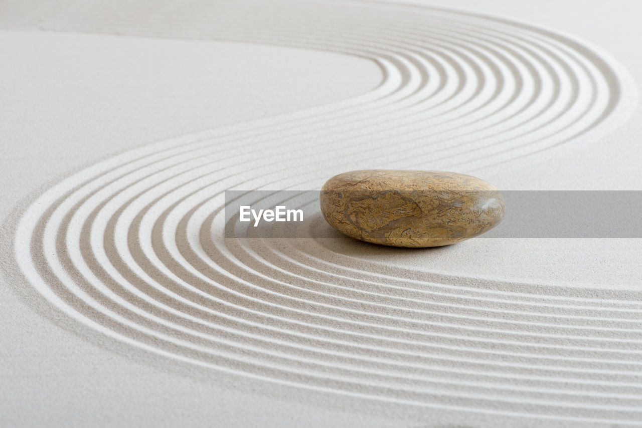 Japanese zen garden with stone in textured sand