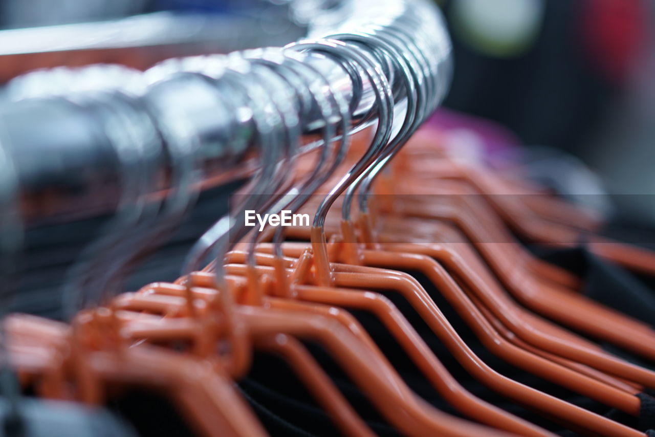 Close-up of coathangers on rack