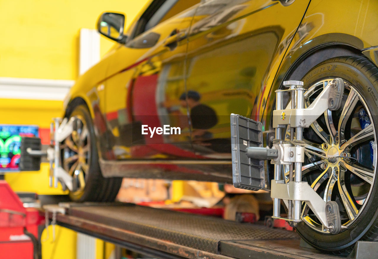 Wheel alignment ,car on stand with sensors on wheels for wheels alignment camber check in workshop