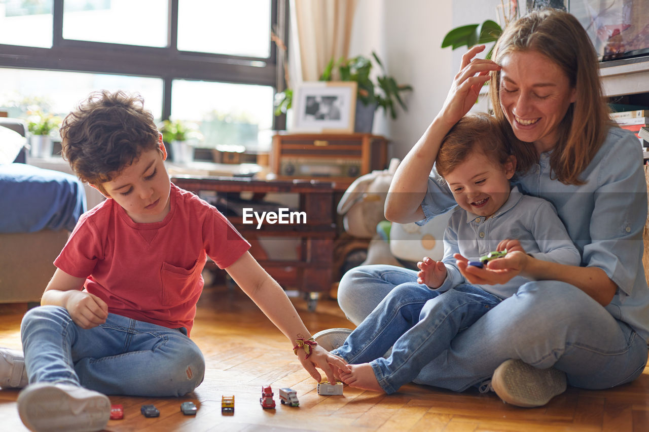 Loving moment of happy mother playing with her children