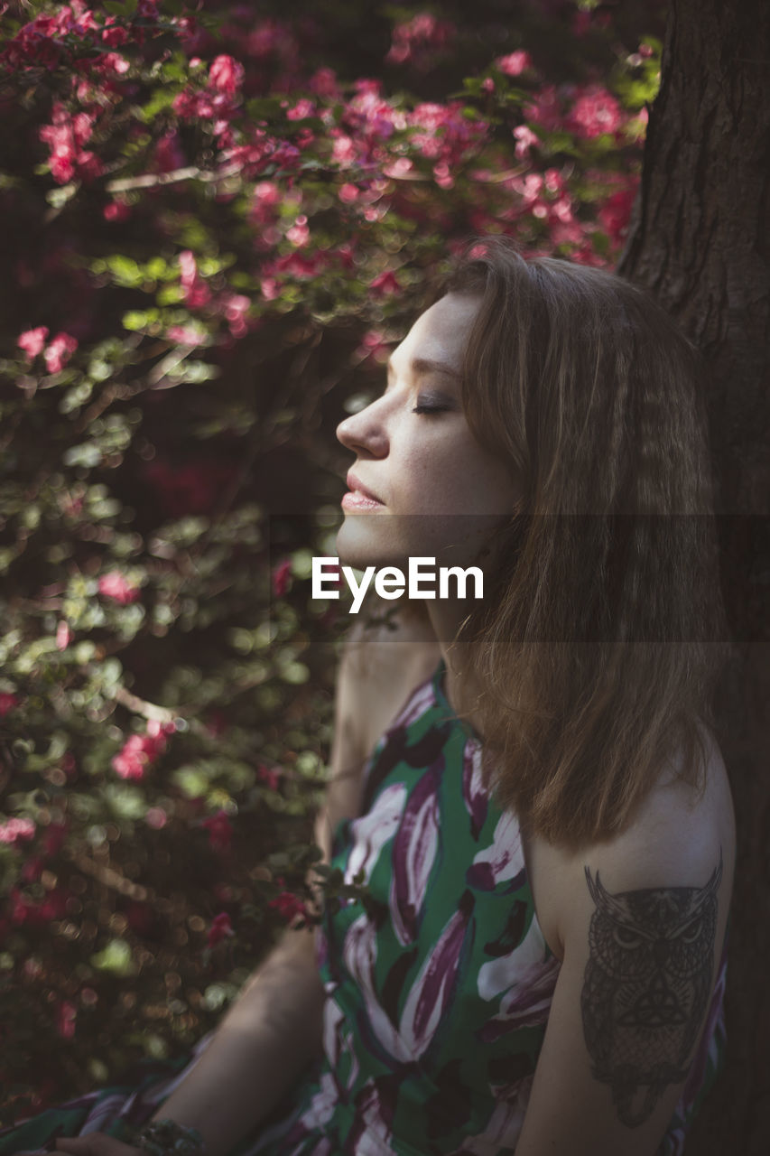 Close up woman resting with closed eyes in garden portrait picture